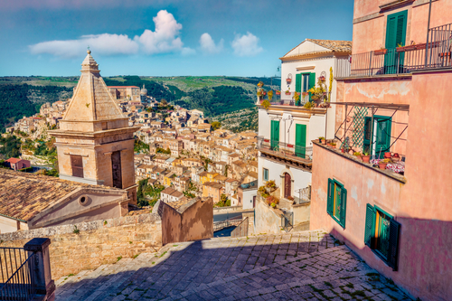 Сharm of the ancient cities of Europe. Sunny spring cityscape of Ragusa town with Church of St Mary of the Stairs on background. Wonderfulmorning scene of Sicily, Italy