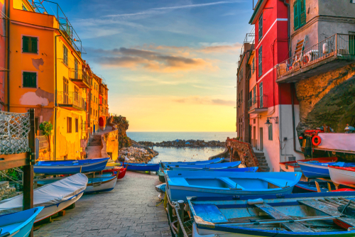 Riomaggiore village street, boats and sea at sunset, Cinque Terre National Park, Liguria, Italy