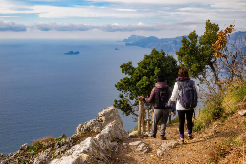 Two hikers viewing the beautiful Amalfi Coast from the Path of the Gods 