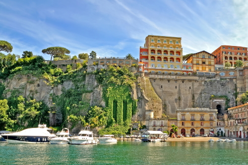 View of the harbor and cliffs of Sorrento with various historic buildings on Amalfi Coast in Campania, Italy