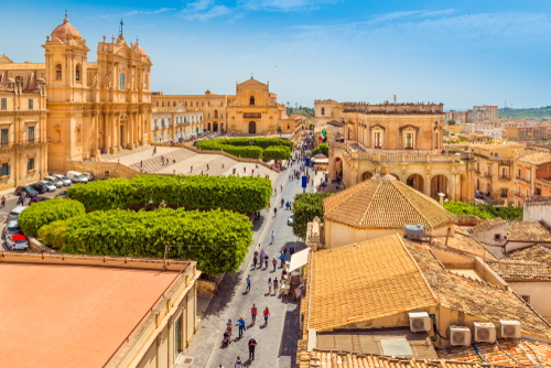 Noto cityscape, view of the central street with walking tourists. Noto, Syracuse province, Sicily, Italy