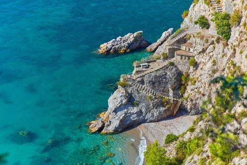 Breathtaking view from Conca dei Marini and the secluded beach below, along the main road of the Amalfi Coast, Campania, Italy