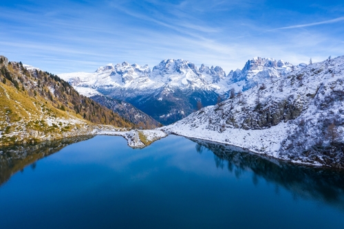 Mountain Lake in Dolomites mountains, clear mountain water reflecting the snowy peaks of the mountains. Ritorto Lake In Dolomites. Lago Ritorto in Madonna di Campiglio, Trentino Alto Adige, Italy
