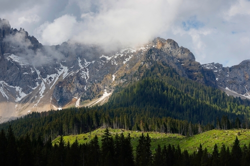 Passo Costalunga in Dolomites, hillside of mount Catinaccio (Rosengarten) on the background, Trentino Alto Adige, Italy