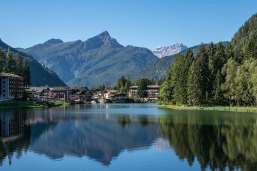 Alleghe lake in summer, a small alpine lake in the Veneto Alps at the foot of the Belluno Dolomites, Italy