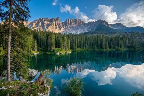 Paradise landscape at Karersee (Lago di Carezza, Lake Carezza) in the Dolomites of Italy at Mount Latemar, province of Bolzano, South Tyrol, Trentino Alto Adige. Blue and crystal clear water