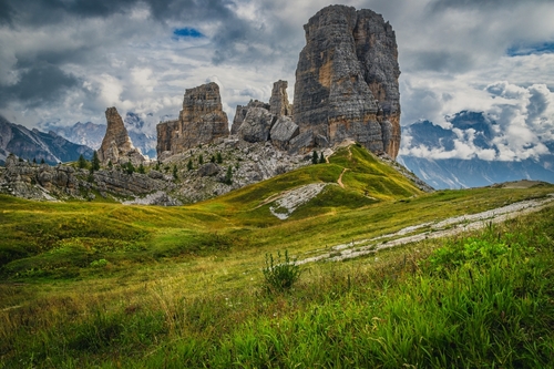 Beautiful green field and hiking trails around the Cinque Torri cliff formations, Dolomites, Italy