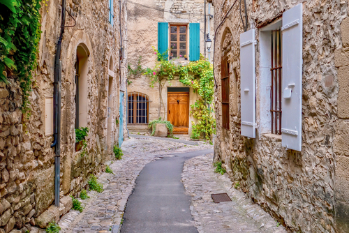 A quaint narrow lane running through the medieval area of Vaison la Romaine, a village in the Vaucluse region of Provence, France