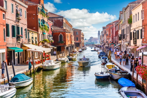 Island murano in Venice, Veneto, Italy. View on canal with boat and motorboat water. Picturesque landscape