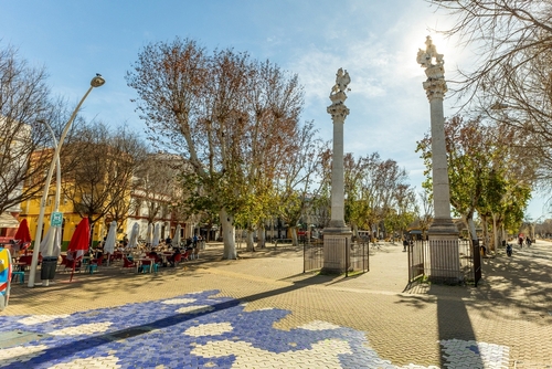 Alameda de Hércules in Seville at midday, with people walking and enjoying the restaurants and bars in the area, Seville, Andalusia, Spain