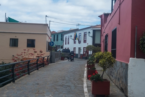 Cobbled street with colorful traditional houses in the village of Agulo located in green valley at north coast, La Gomera island, The Canaries, Spain