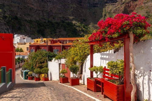 Red benches on the streets in the village of Agulo in the north of La Gomera island, The Canaries, Spain
