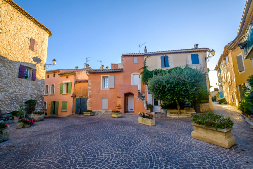 Facades of colorful houses, windows with wooden shutters, village Ventabren, Provence, France