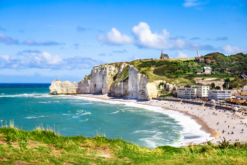 Etretat Aval cliff, rocks and natural arch landmark and blue ocean. Normandy, France, Beatiful summer panorama