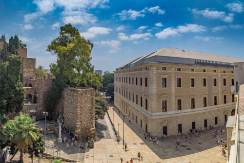 View of the Alcazaba, arab castle and Palacio de la aduana (Malaga museum) in Malaga, Andalusia, Spain on a Sunny day