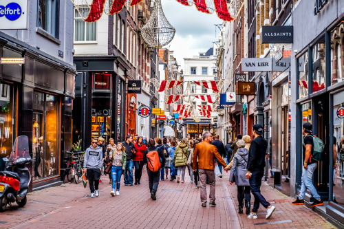The busy Kalverstraat, a famous shopping street in the center of the old city of Amsterdam on a nice fall day, Holland