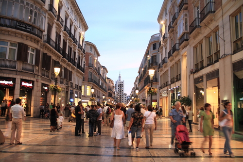 People walking and shopping on Larios street, the main street of Malaga, Andalusia, Spain
