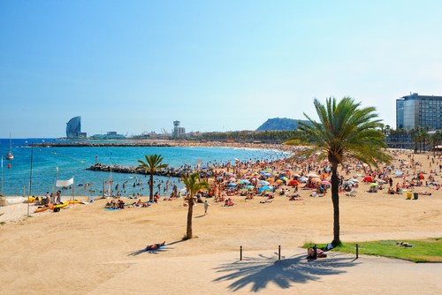 View of many people visiting Barcelona beach on a summer day, Barcelona, Catalonia, Spain