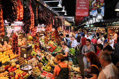 Tourists in famous La Boqueria market, one of the oldest markets in Europe that still exist, established in 1217, Barcelona, Catalonia, Spain