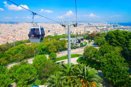 Tourists descend in cabin of cable car (Teleferic de Montjuic) from the hill of Montjuïc, Barcelona, Catalonia, Spain