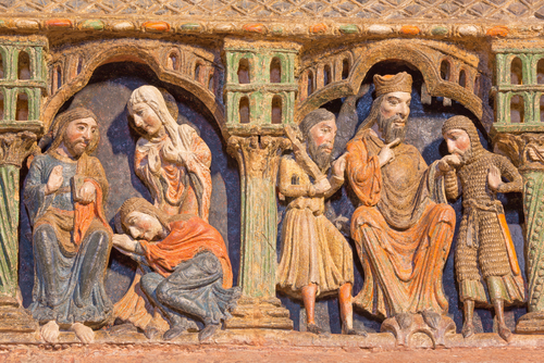 Detail of reliefs from life of saints on the romanesque polychrome funeral memorial Cenotafio de los Santos Hermanos Martires church Basilica de San Vicente, Avila, Spain