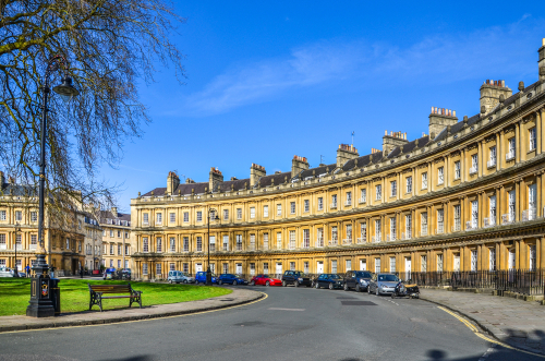 The landmark Royal Circus is seen on a city centre street in Bath, Somerset, England UK. The Circus comprises of luxury Georgian era town houses in a prime location