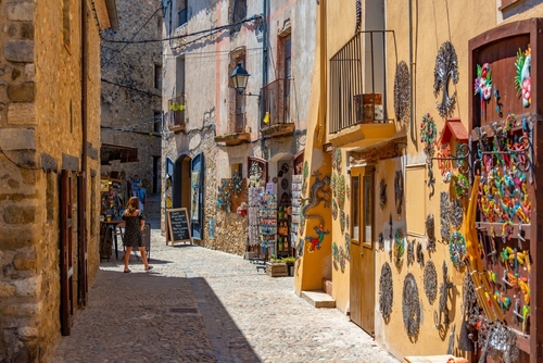 Medieval street with small shops in the Spanish town of Besalu, Catalonia, Spain