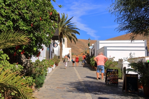 People walking through a street in the old town of Betancuria, Fuerteventura Island, Canary Islands, Spain