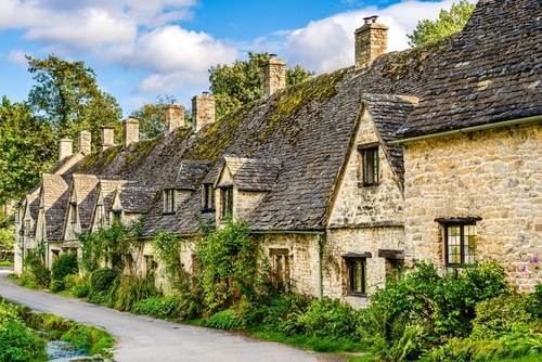 Traditional row of stone cottage houses on Arlington Row in Bibury village, Gloucestershire, The Cotswolds, England, UK