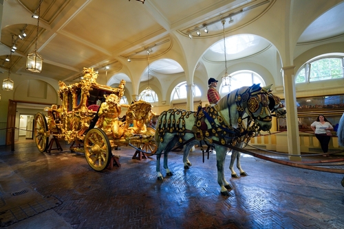 The Gold State Coach, that King Charles III and Queen Camilla rode in during their Coronation procession. On display at the Royal Mews, Buckingham Palace, London, England, United Kingdom