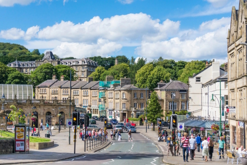 View of people walking in a main street in Buxton in the Peak District National Park, Derbyshire, England, UK
