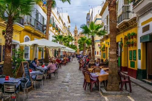 People enjoying lunch outside on the calle de la virgen in Cadiz, Andalusia, Spain