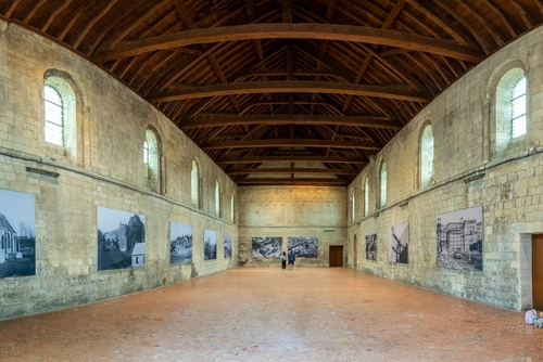 Castle of Caen. View inside a building under repair with pictures works on the wall, Normandy, France