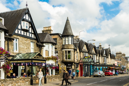 People walking in the main street in Pitlochry on a Sunny day, Cairngorms National Park, Scotland, UK
