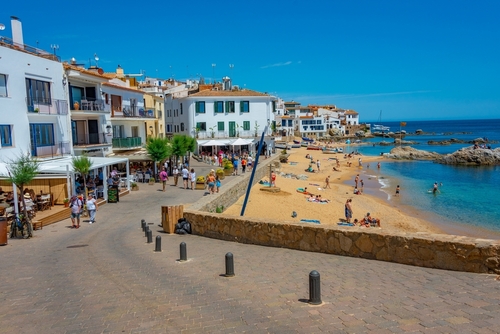 People are strolling at seaside promenade at Calella de Palafrugell, Costa Brava, Catalonia, Spain
