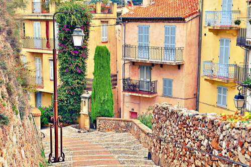 Street with buildings and paved brick walkway in Cannes, French Riviera, France