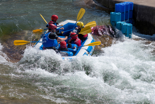 People in a Rafting boat at the Cardiff International White Water Centre in Cardiff, Wales, United Kingdom