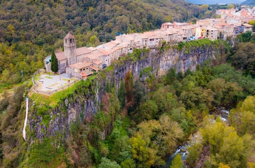 Aerial view of Castellfollit de la Roca, medieval Catalan hamlet on cliff on Autumn day, Catalonia, Spain