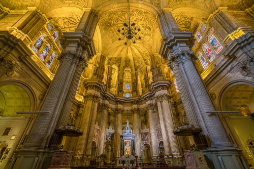 Interior view of columns and glass-stained windows at the Cathedral of Malaga (Basilica de la Encarnacion), Andalusia, Spain