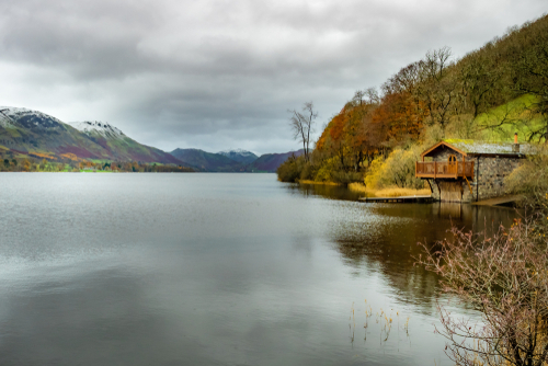 A quiet boathouse in the serene landscape of Coniston Water in the Lake District National Park, Cumbria, England, UK