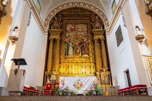 Interior view of the Baroque gold decorated altar with Saint Teresa of Jesus statue in the Convent of Santa Teresa in Avila, Spain