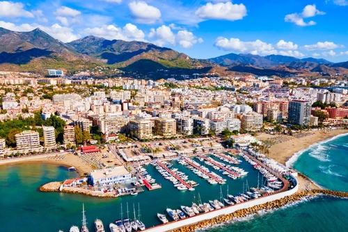 Aerial view of Marbella and its marina with turquise waters and cloudy sky on a Sunny day, near Malaga, Costa del Sol, Andalusia, Spain