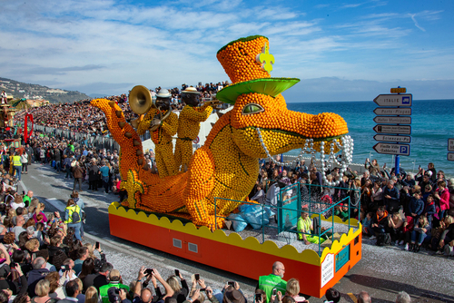 Parade of citrus fruit floats and folklore groups at the corso of the Menton Lemon Festival, Cote d'Azur, France
