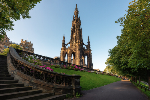 Scott monument in West Princes Street Gardens, during clear blue sky day, Edinburgh, Scotland, UK