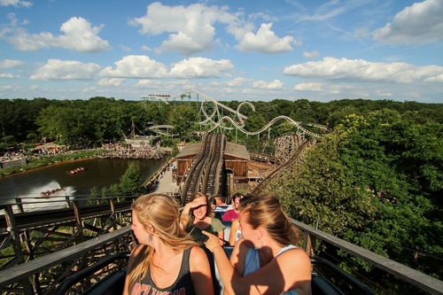 Blonde Dutch girls in a train of the wooden roller-coaster 