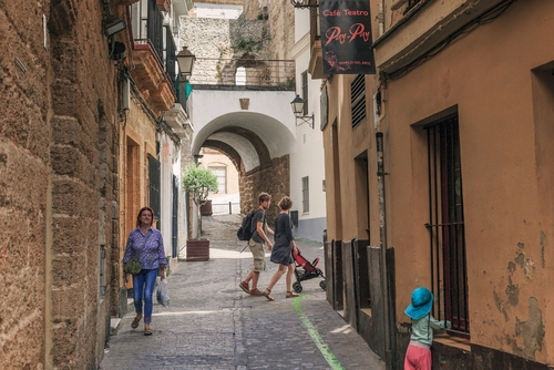 These are residents at the crossroads of old narrow streets in the del Populo district, Cadiz, Andalusia, Spain