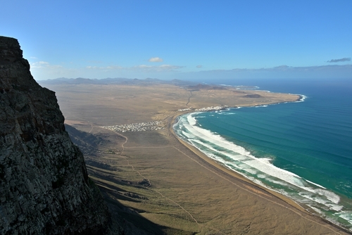 View of Famara beach from the mountains, The coastline of Lanzarote, View of the surfer hotspot Famara on Lanzarote Island, The Canary Islands, Spain
