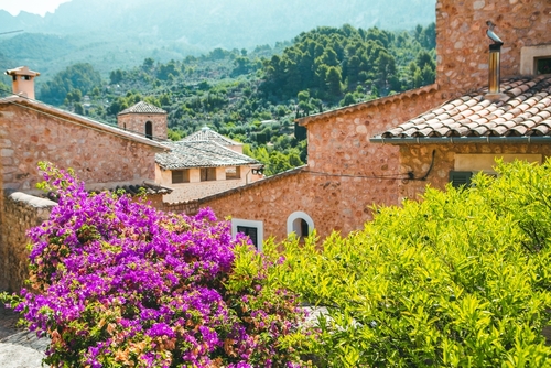 Beautiful landscape on Mallorca island, view of the idyllic old mediterranean village Fornalutx with sunshine, Balearic islands, Spain