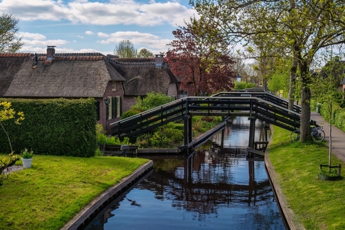 Beautiful Dutch brick house with traditional roof in the village of Giethoorn, a famous tourist destination near Amsterdam, Holland
