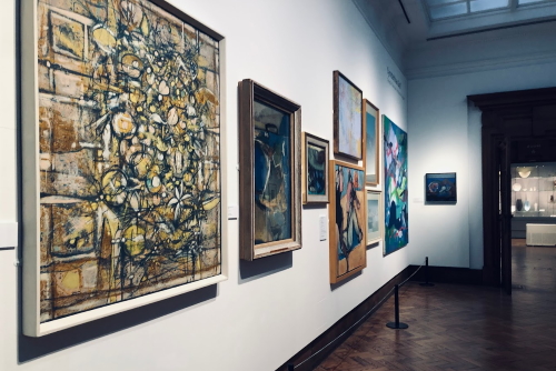 Paintings hanging on the wall at the Glyn Vivian Art Gallery in Swansea, Wales, UK
